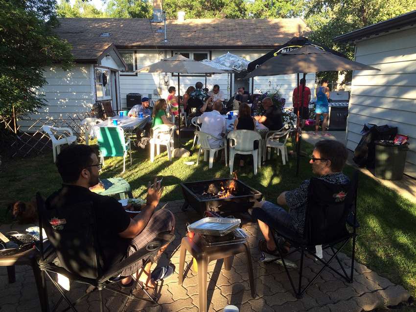 A group of friends enjoying a cozy evening around a fire pit in O’Fallon, MO.